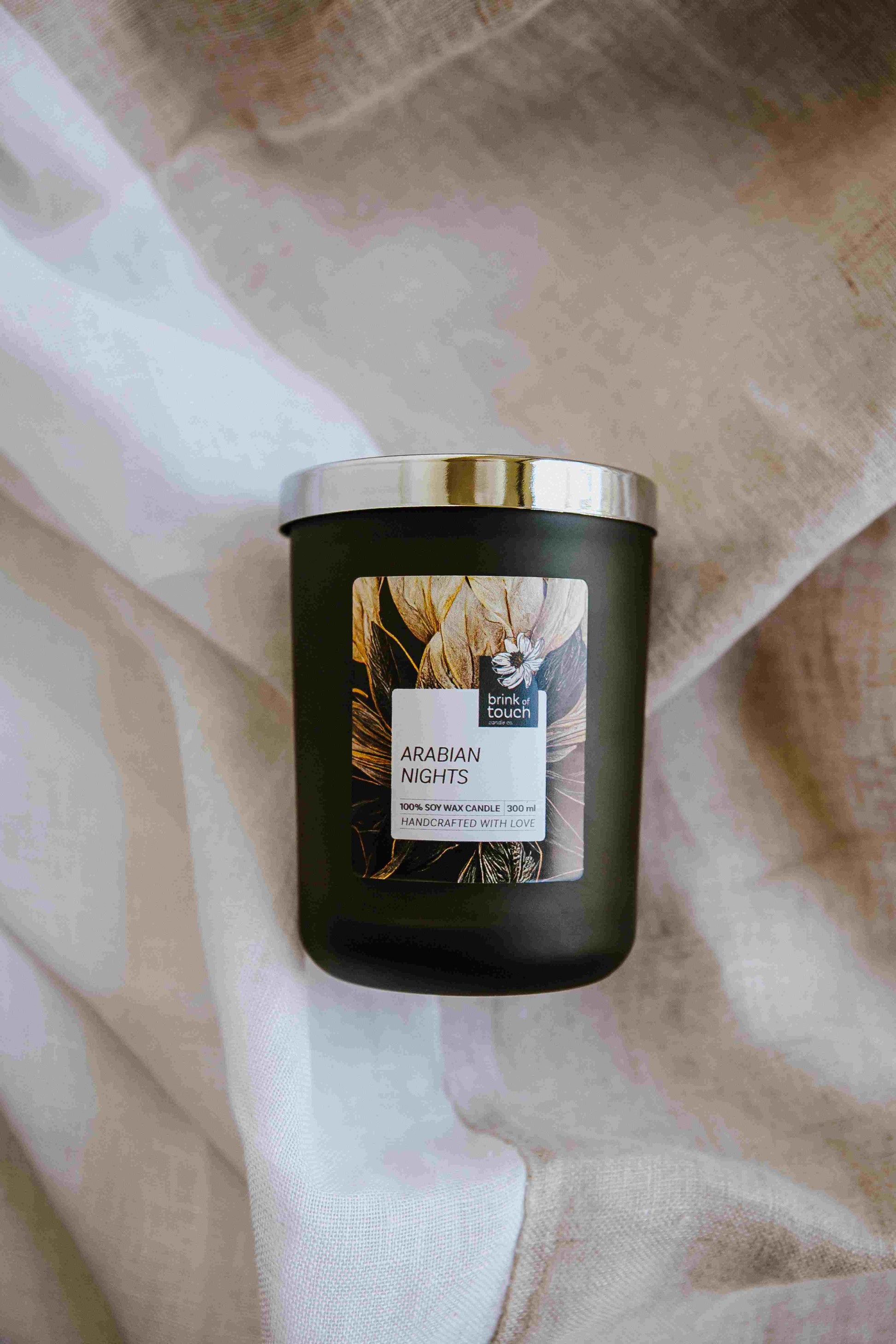 arabian nights candle. Like the edges of a dishdasha brushing against the sands of the sahara, notes of cedar and sandalwood are released from the base notes, drifting into a spicy fruit peel breeze. wisps of fragrant tobacco seal this middle east inspired aroma.